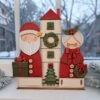 Santa with house & Mrs Claus on a base