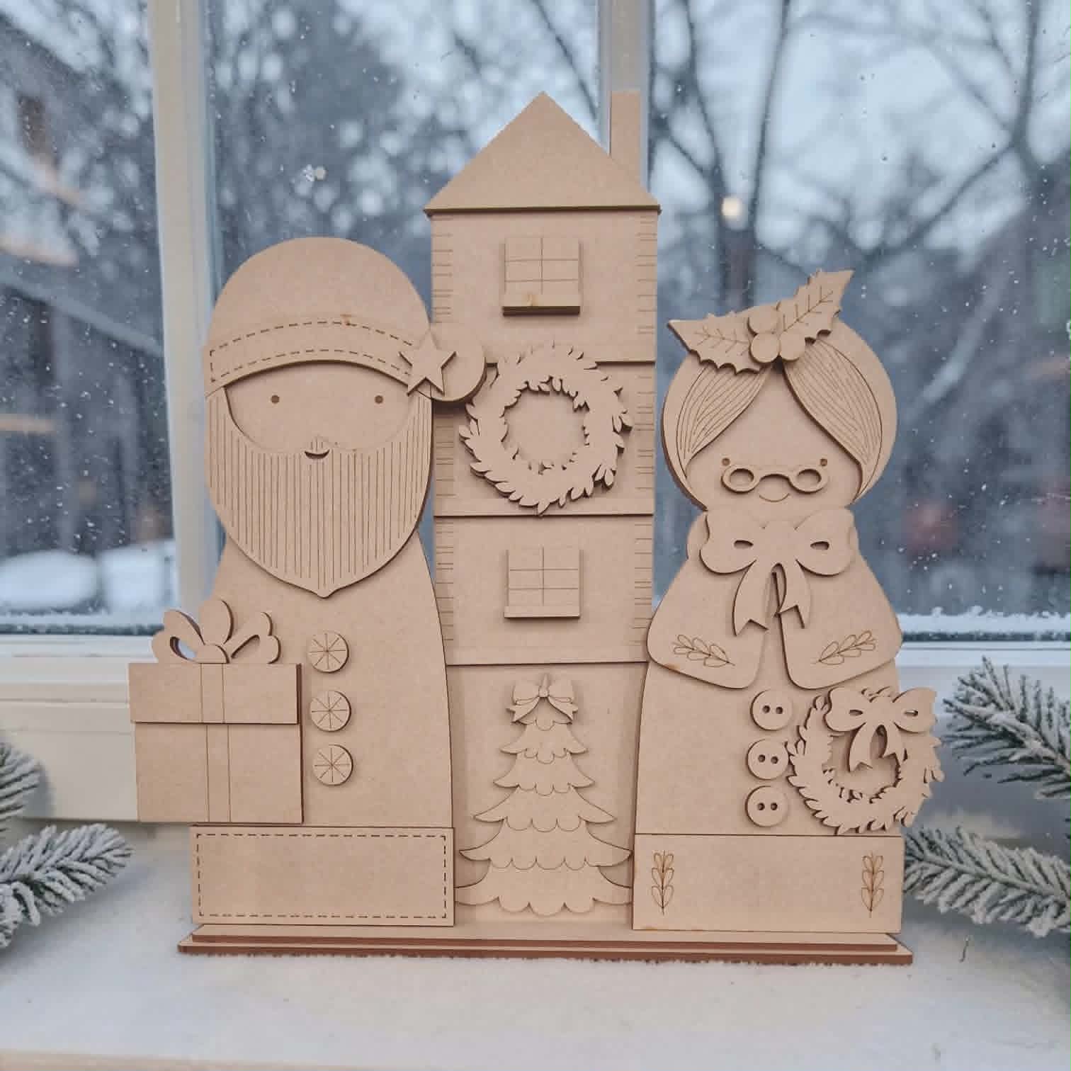 Santa with house & Mrs Claus on a base