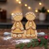 Pair of Gingerbreads sitting on Rolling Pin