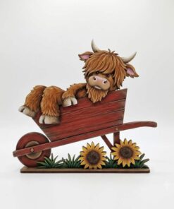 Highland in wheelbarrow with sunflowers